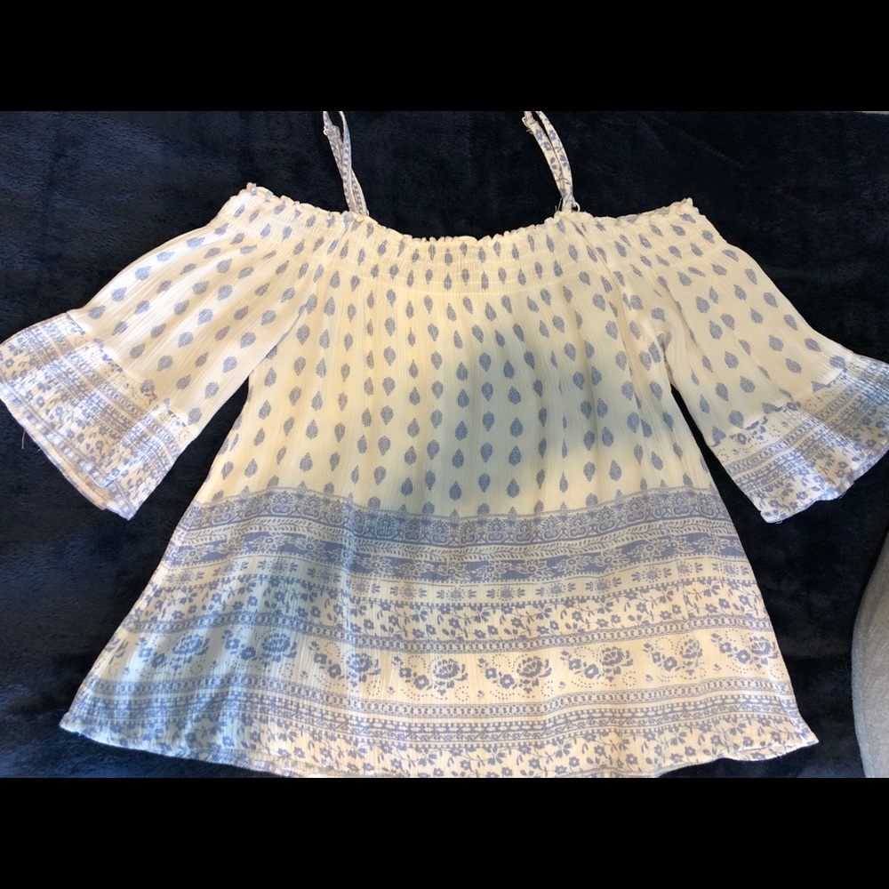 Quarter flow off the shoulder flounce top